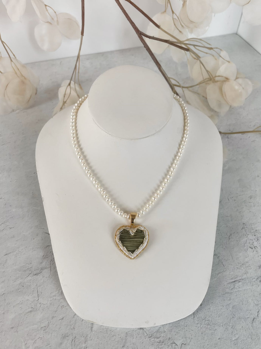 Green quilled heart on pearl necklace